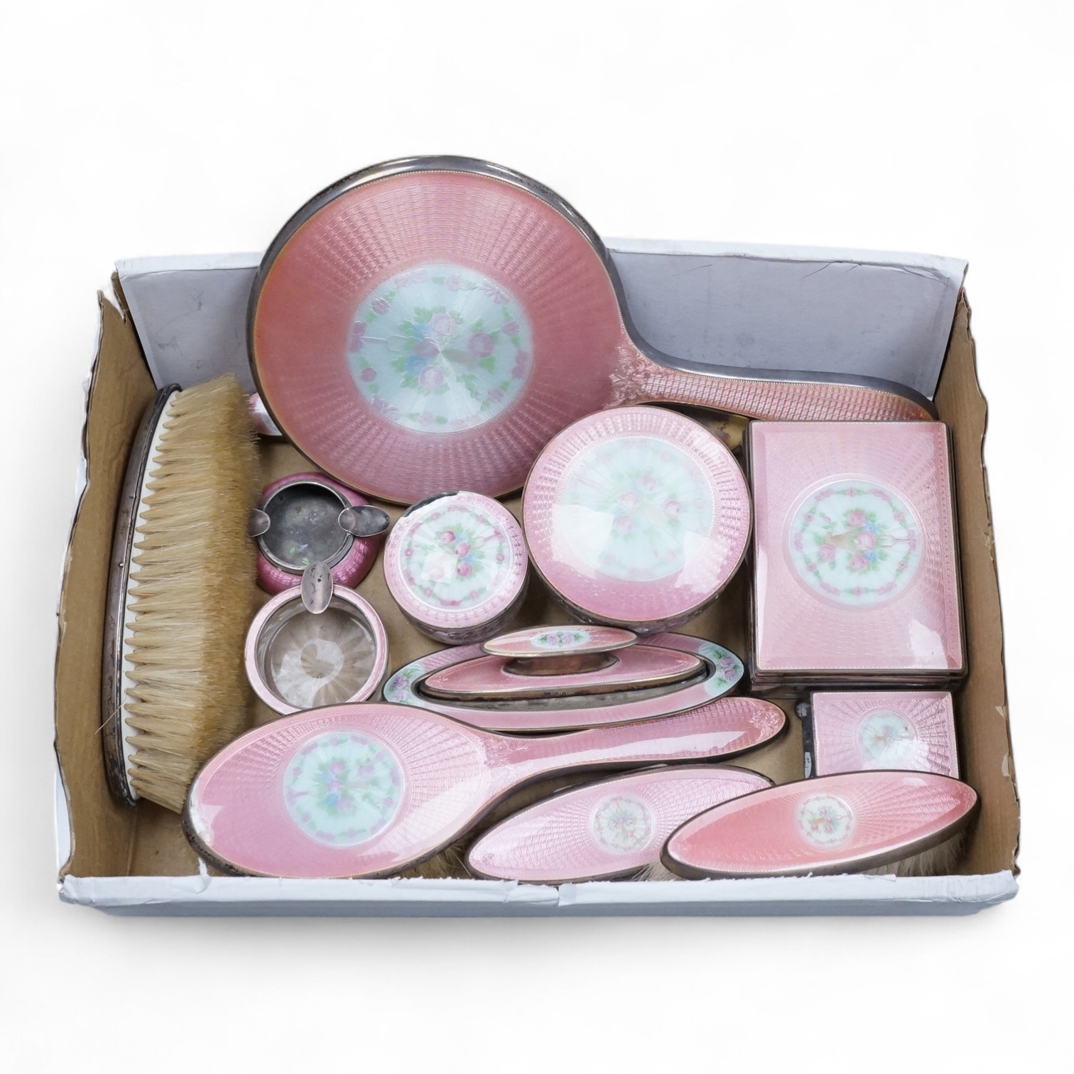 An early century North American sterling and enamel dressing table set by Theodore W. Foster & Bro, comprising fourteen items including hand mirror, 29.1cm, brushes, trinket box, nail buffer on stand, toilet jars, powder